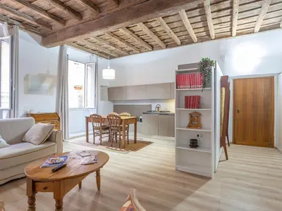 a living room with a couch and a table at Colosseum house in Rome