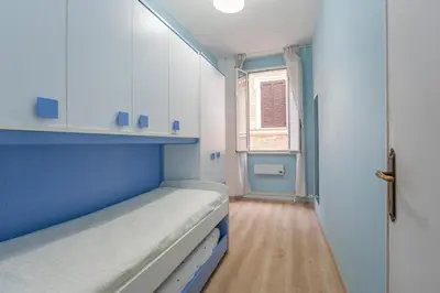 a small room with a bed and a window at Colosseum house in Rome