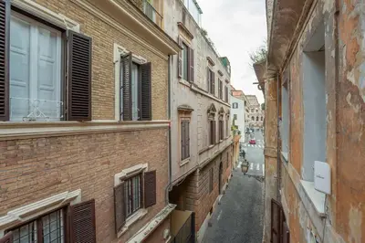 an alley in an old city with brick buildings at Colosseum house in Rome