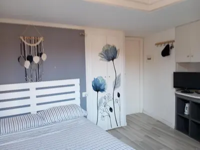 a bedroom with a bed with blue flowers on the wall at Trastevere onlyone in Rome