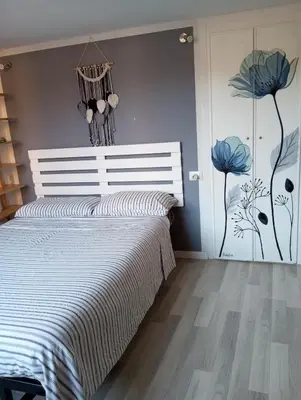 a bedroom with a bed with blue flowers on the wall at Trastevere onlyone in Rome