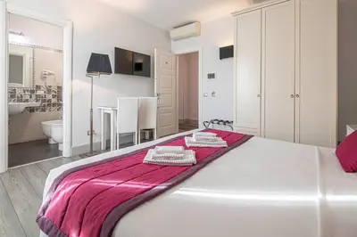 a bedroom with a bed with two towels on it at Residenza Castrense in Rome