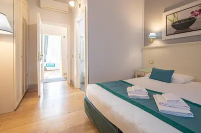 a bedroom with a bed with towels on it at Suite Castrense in Rome