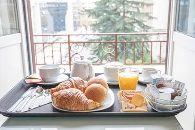 a tray with breakfast food on a table with a window at Suite Castrense in Rome