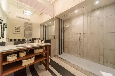 a bathroom with a sink and a shower at La Porta Rossa di Borgo - Vatican Luxury Suite in Rome