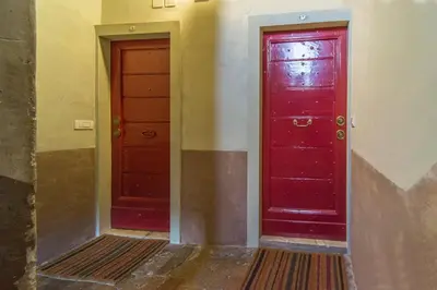 two red doors sitting next to each other at La Porta Rossa di Borgo - Vatican Luxury Suite in Rome
