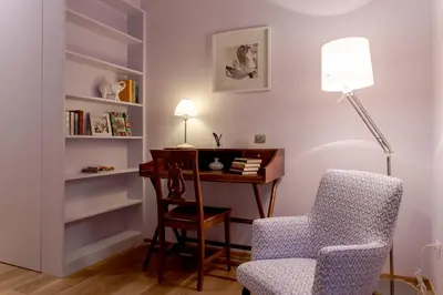a room with a desk and a chair and a lamp at La Porta Rossa di Borgo - Vatican Luxury Suite in Rome
