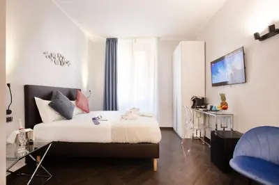a hotel room with a bed and a desk at Cloud 9 Hotel in Rome