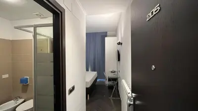 a bathroom with a toilet and a sink and a mirror at Cloud 9 Hotel in Rome