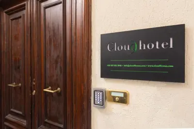 a door with a hotel sign and a remote control at Cloud 9 Hotel in Rome