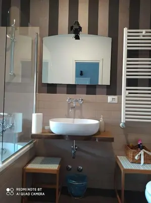 a bathroom with a sink and a mirror at Vanity Apartment - 4 bedrooms with 4 bathrooms - AC & WIFI in Rome