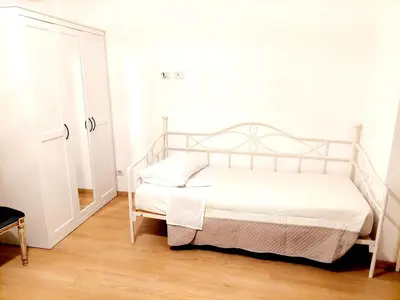 a bedroom with a white bed and a white cabinet at Vanity Apartment - 4 bedrooms with 4 bathrooms - AC & WIFI in Rome