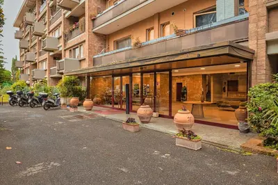a building with motorcycles parked in front of it at Plaza Cheery Suite in Rome
