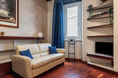 a living room with a couch and a television at GuestHost - Piazza Navona Petite House in Rome