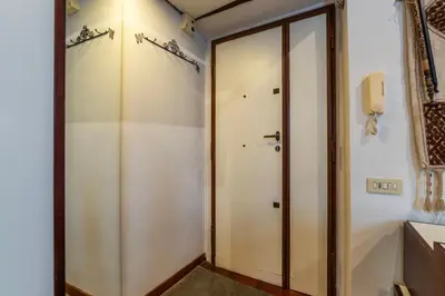 a hallway with a glass door and a closet at GuestHost - Piazza Navona Petite House in Rome