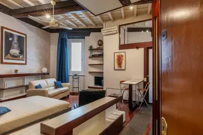a bedroom with a bed and a living room at GuestHost - Piazza Navona Petite House in Rome