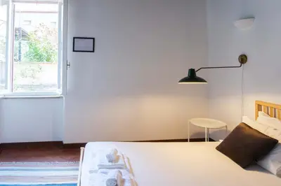 a bedroom with a bed and a lamp and a window at EasyTopStay - Cosy Flat near Castel S Angelo in Rome