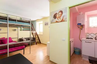 a room with a bunk bed and a living room at Holiday House Esedra in Rome