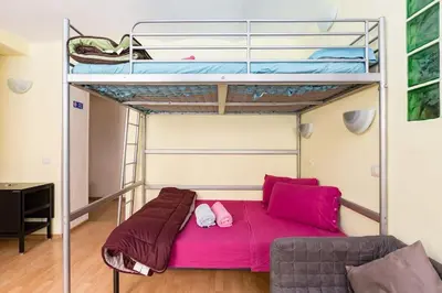 a bedroom with a bunk bed and a couch at Holiday House Esedra in Rome