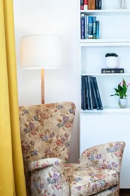 a living room with a chair and a lamp at La casa di Livia in Rome