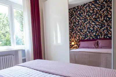 a bedroom with a bed and a wall mural at La casa di Livia in Rome