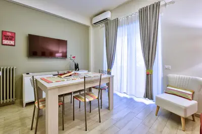 a living room with a table and chairs and a television at Marigiò Vatican Apartment in Rome