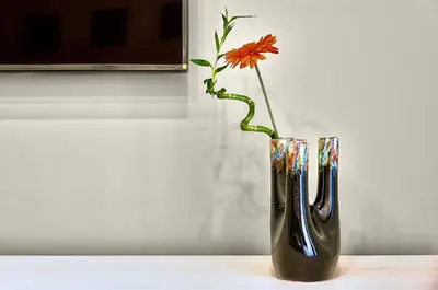 a vase with a flower in it on a table at Marigiò Vatican Apartment in Rome