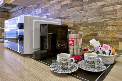 two coffee cups on a counter next to a microwave at Marigiò Vatican Apartment in Rome