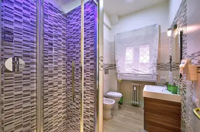 a bathroom with a shower and a toilet and a sink at Marigiò Vatican Apartment in Rome