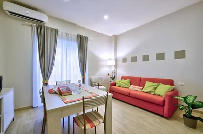a dining room table with plates and wine glasses at Marigiò Vatican Apartment in Rome