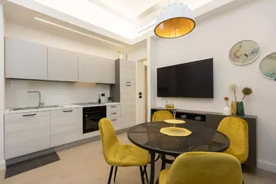 a kitchen with a dining room table and yellow chairs at SolferinoNove in Rome