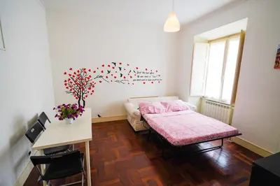 a bedroom with a bed and a table and a table sidx sidx sidx at Holiday House Naiadis in Rome