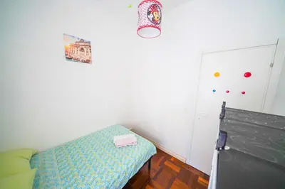 a small room with a bed and a table at Holiday House Naiadis in Rome