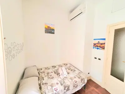 a small room with a bed in a room at Holiday House Naiadis in Rome