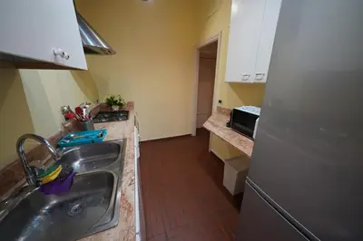a kitchen with a sink and a refrigerator at Holiday House Naiadis in Rome