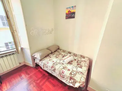 a small bedroom with a bed in a room at Holiday House Naiadis in Rome