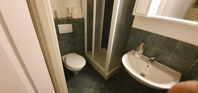 a small bathroom with a toilet and a sink at Holiday City Centre in Rome