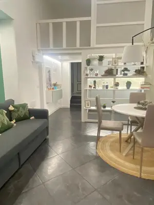 a living room with a couch and a table at Loft Torlonia in Rome