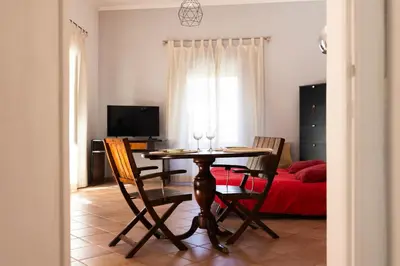 a dining room with a table and chairs and a bed at Obiettivo Roma in Rome