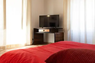 a bedroom with a bed and a flat screen tv at Obiettivo Roma in Rome