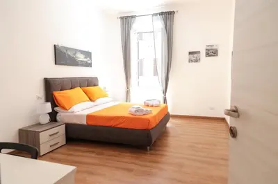 a bedroom with a bed with orange and yellow pillows at Trastevere Magic House Luxury Suite in Rome