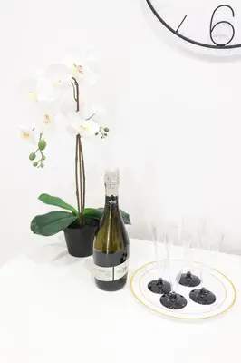 a bottle of wine next to a potted plant at Trastevere Magic House Luxury Suite in Rome