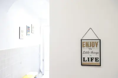 a bathroom with a sign that reads enjoy the little things life at Trastevere Magic House Luxury Suite in Rome