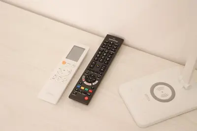 a remote control sitting next to a wii controller at Trastevere Magic House Luxury Suite in Rome