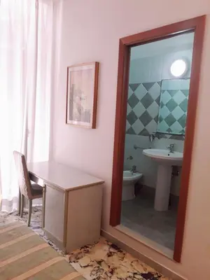 a bathroom with a mirror and a sink at Gioia Guest House in Rome
