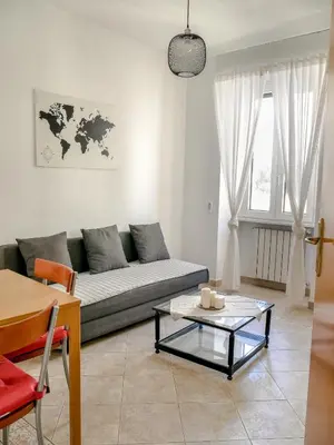 a living room with a couch and a table at Modern 1 Bedroom near metro in Rome