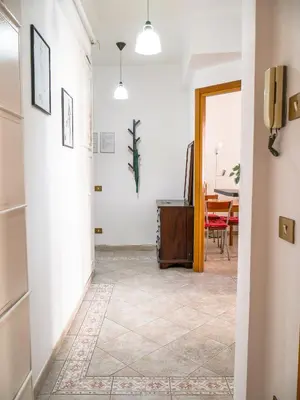 a hallway with a dining room with a table at Modern 1 Bedroom near metro in Rome