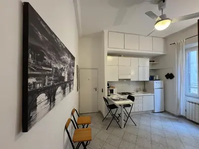 a kitchen with a table and chairs in a room at Cozy apartment in Rome Trastevere in Rome