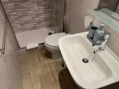 a bathroom with a white sink and a toilet at Cozy apartment in Rome Trastevere in Rome
