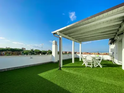 a patio with grass and chairs on a roof at Al 13 - La Terrazza in Rome